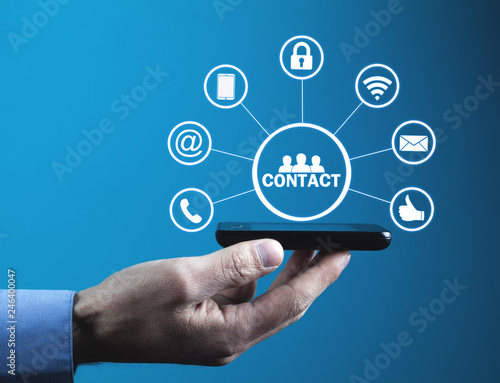 Man holding phone with contact icons.