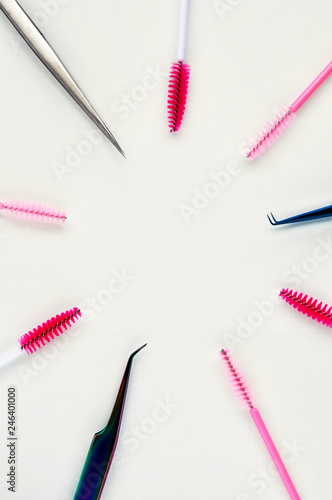 Beauty of eyelashes and eyebrows: eyelash extension tools and decor on white background with copy space. top view. Flatley