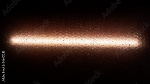 Bubble wrap with water droplets, backlit with LED light. Texture and background