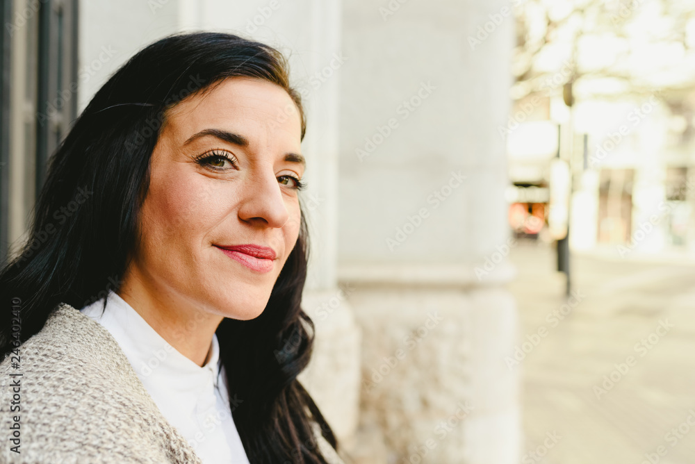 Portrait of mature woman waiting outside, side view. Portrait of mature woman waiting outside, side view.