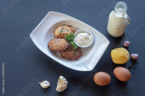 potato pancakes on a white plate. Milk, eggs, farm products.