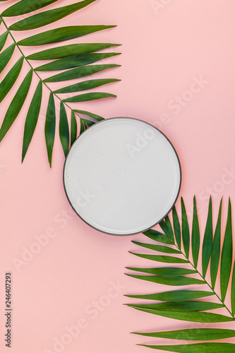 Empty plate mockup with green tropical leaves