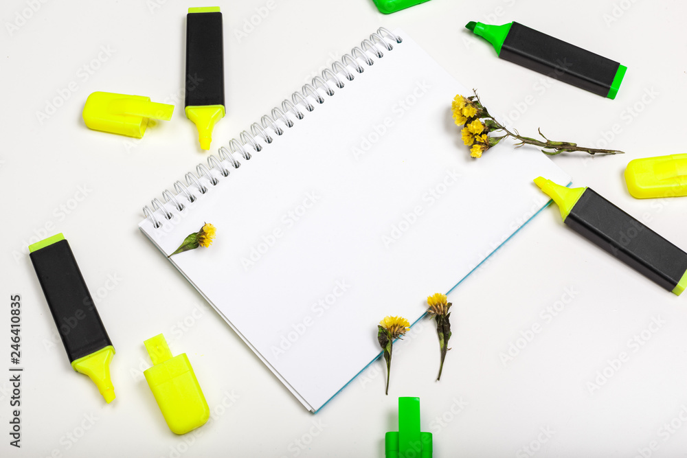 highlighters and blank notepad paper sheet flat lay on a desk highlighters and blank notepad paper sheet flat lay on a desk
