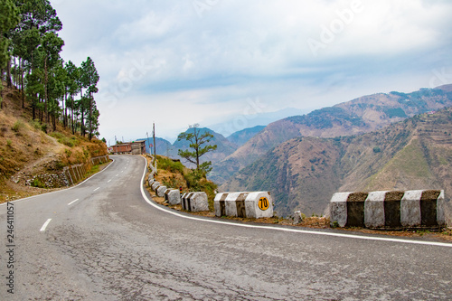 Scenic road through the valley of banikhet dalhousie himachal pradesh covered with mountain and trees. Driving uphill scenic road travel concept photo