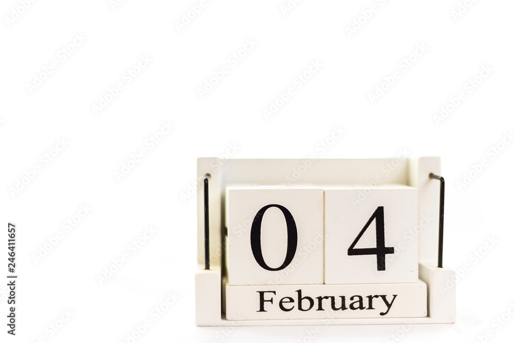 the day of February on a white clear background. a wooden desktop calendar that reminds us of what date we are today. the day of February on a white clear background. a wooden desktop calendar that reminds us of what date we are today.