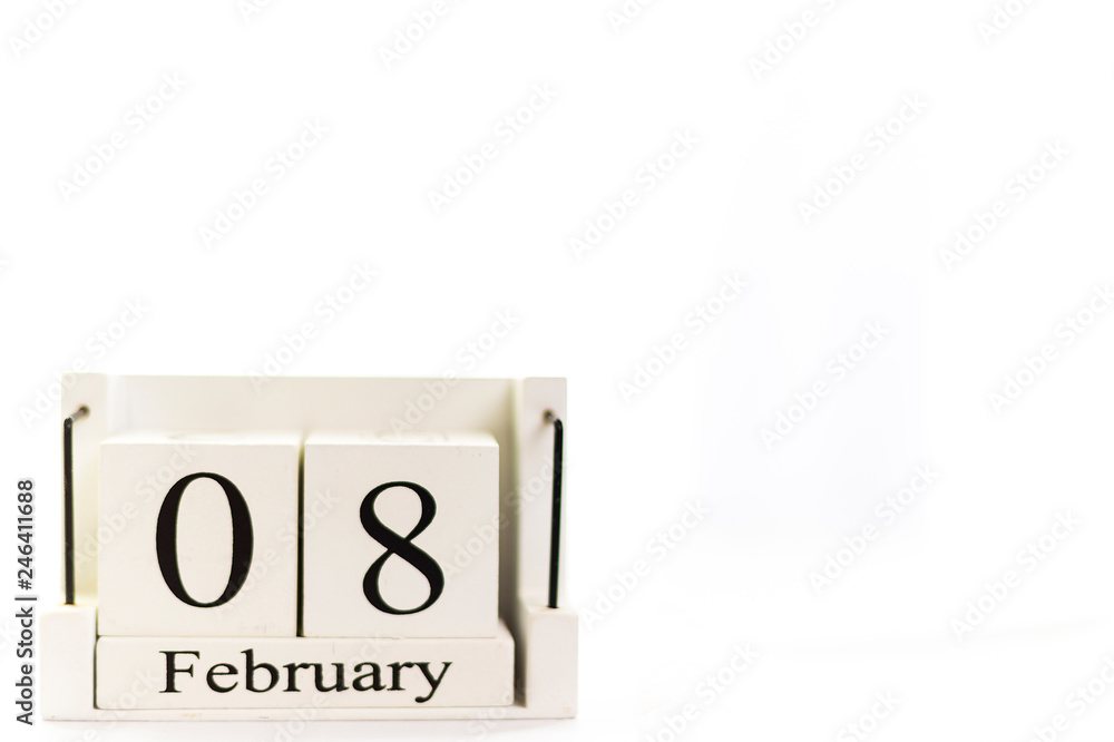 the day of February on a white clear background. a wooden desktop calendar that reminds us of what date we are today. the day of February on a white clear background. a wooden desktop calendar that reminds us of what date we are today.