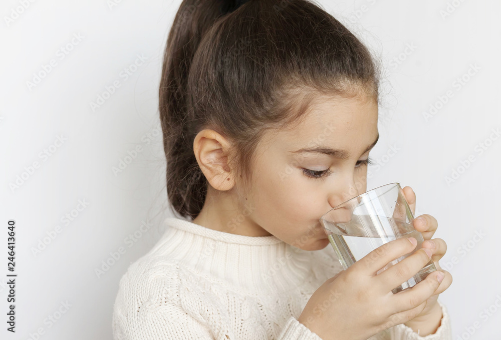 Cute child girl drinking water on white background. Pure water. Cute child girl drinking water on white background. Pure water.