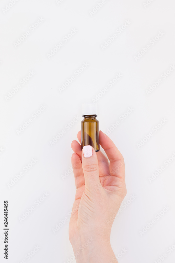 Woman hand with small glass bottle isolated Woman hand with small glass bottle isolated