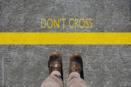 man's shoes view from above, words don't cross  and a  limit line