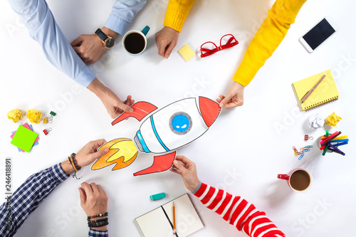 Business people with startup rocket photo