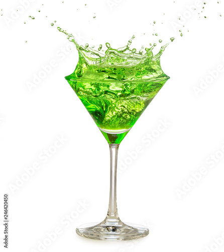 green cocktail splashing in martini glass isolated on white