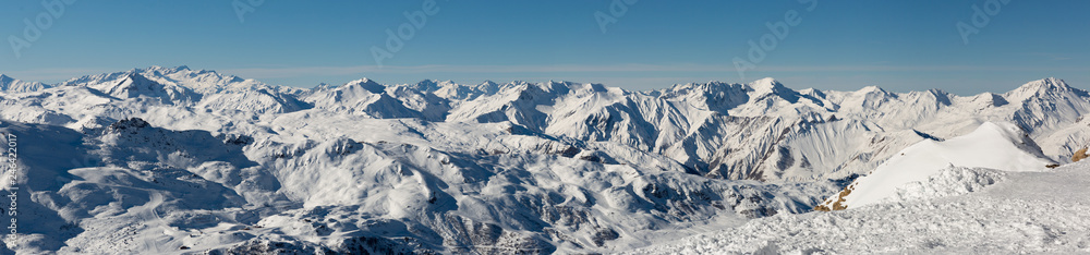 Beautiful alpine panoramic view snow capped mountains. Winter mountain scenery.