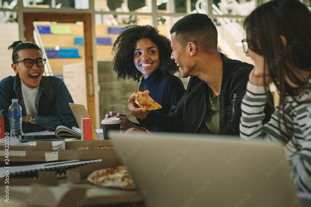 Group of students eating pizza at college canteen Stock Photo | Adobe Stock