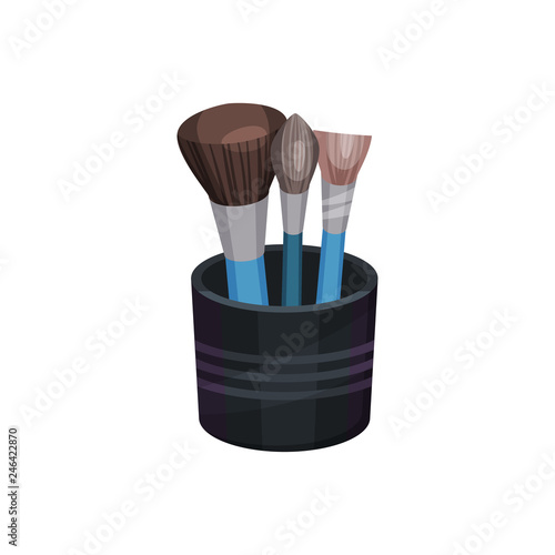 Flat vectoe set of three different professional makeup brushes in small black cup. Cosmetic tools. Beauty industry