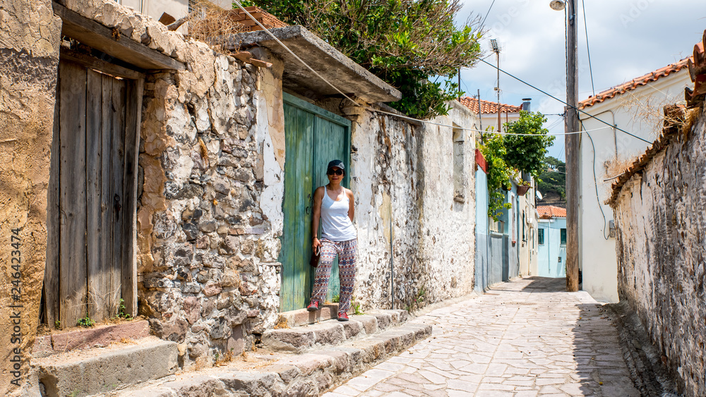 Woman walking through streets of Greek Village