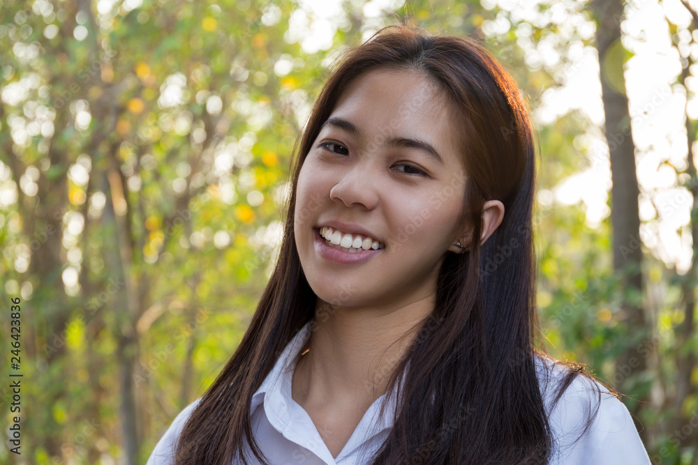 Portrait of asian college woman smiling in blur background witn sunlight. Portrait of asian college woman smiling in blur background witn sunlight.