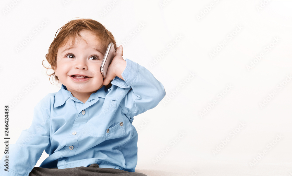 Adorable baby boy talking on mobile phone Adorable baby boy talking on mobile phone