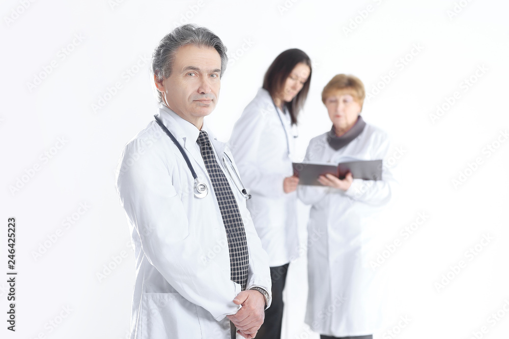 serious therapist doctor on blurred background of colleagues serious therapist doctor on blurred background of colleagues