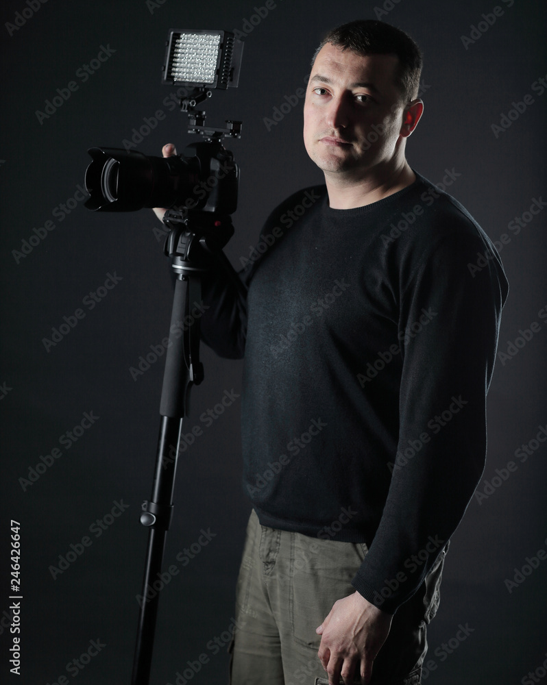 professional photographer with a camera.isolated on black background