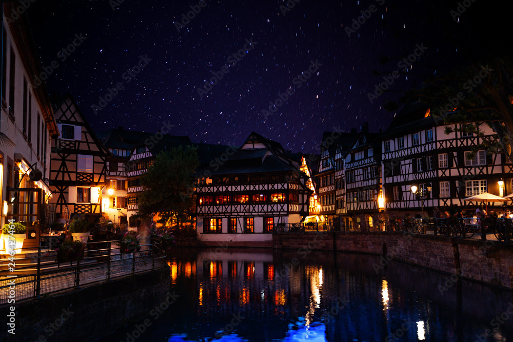 Ill river bank against starry sky in Strasbourg