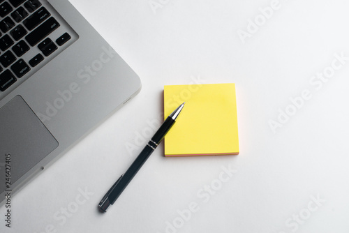 Notebook with black pen, Colorful notepads on the desk, Glasses on the desk with pen and cup of coffee, Computer keyboard with colorful note stick
