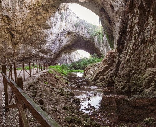 Devetashka cave interior, near Lovech town, Bulgaria. Tunnel of the cave with holes on the top photo