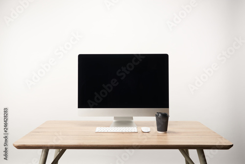 workplace with coffee to go and desktop computer isolated on white with copy space