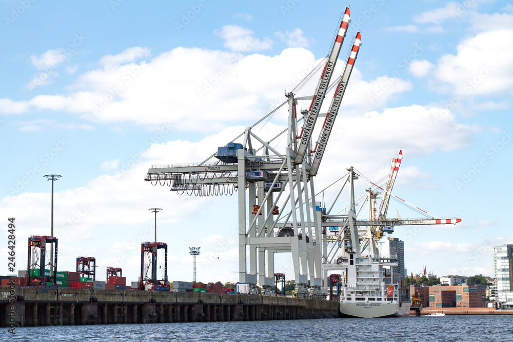 Hamburg, Germany - September 03, 2014: container cranes in a container terminal lightening a freighter