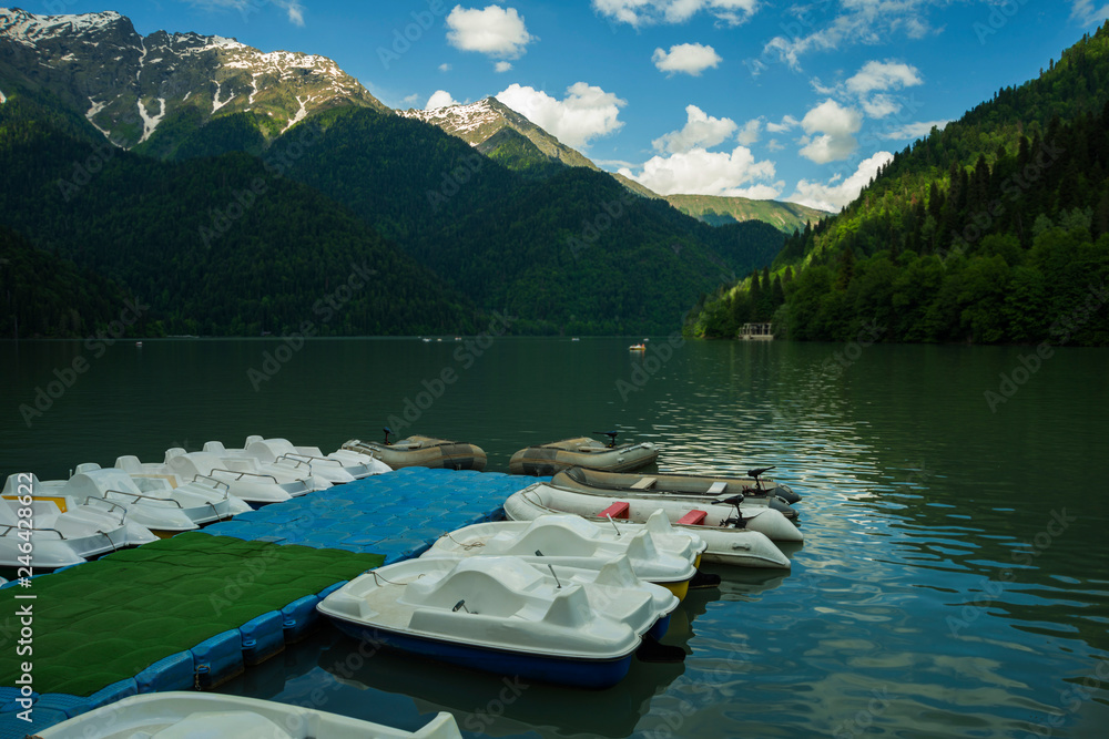 boats, pond, mountains against the blue sky. nature, resort, recreation.
