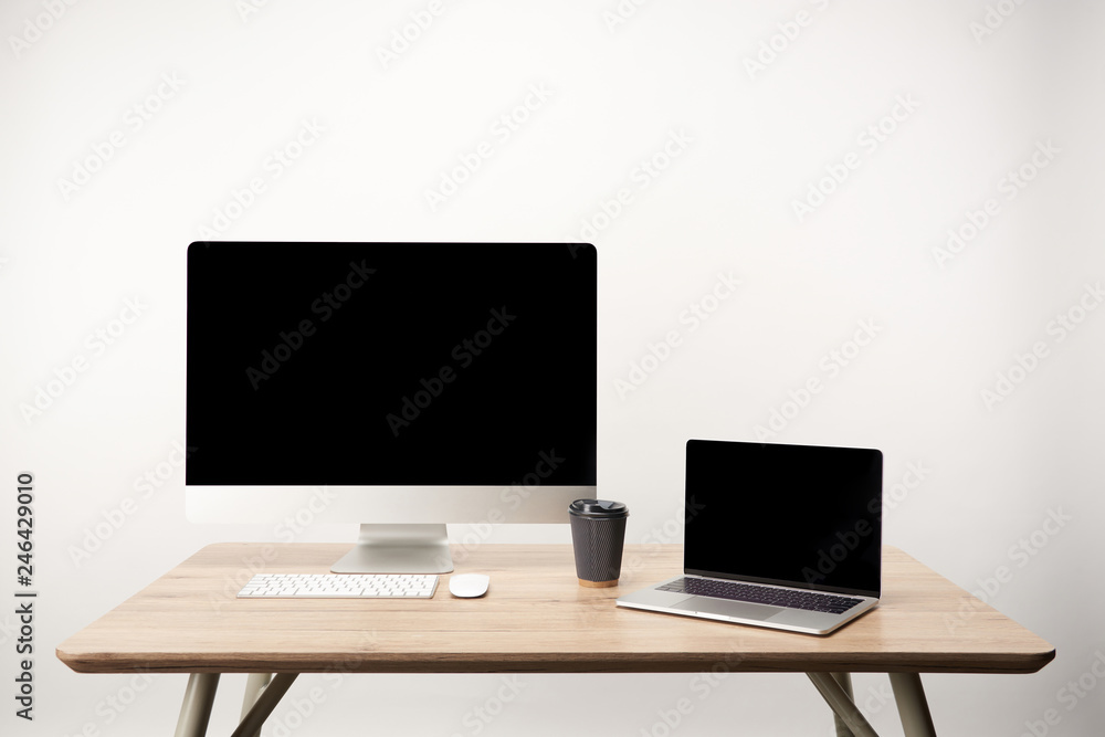 workplace with coffee to go, desktop computer and laptop with copy space isolated on white workplace with coffee to go, desktop computer and laptop with copy space isolated on white