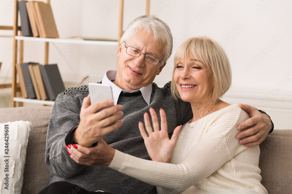Senior couple making video call from smartphone Senior couple making video call from smartphone