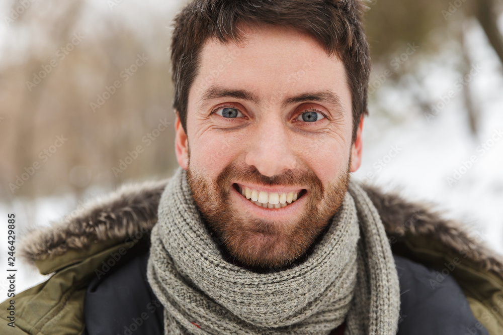 Handsome smiling young man wearing winter jacket Handsome smiling young man wearing winter jacket