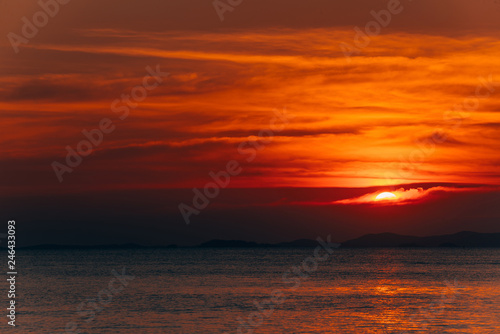 Beautiful blazing sunset landscape and orange sky above it,summer background. © grooveriderz