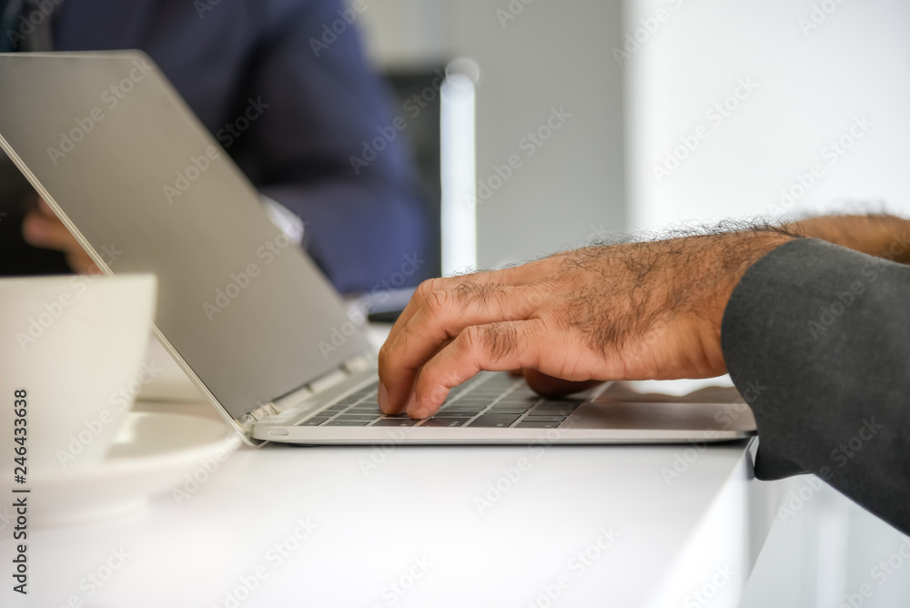 The businessmen are using notebooks to fine information and plan tasks during meeting with the work team, at workplace to business concept. The businessmen are using notebooks to fine information and plan tasks during meeting with the work team, at workplace to business concept.