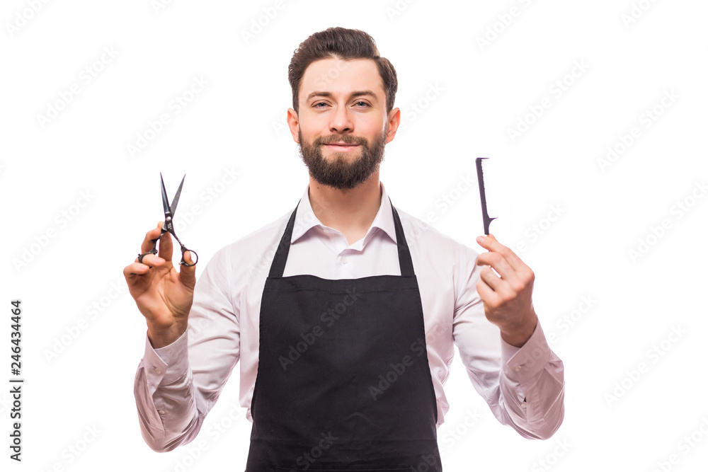 Portrait of cheerful joyful barber with stubble in shirt having scissors, tools, equipments in hands looking at camera isolated on white background