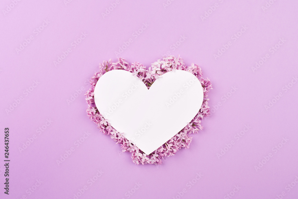 white heart decorated with lilac flowers on purple background. Card for Valentine's day, mother's day, women's day with love