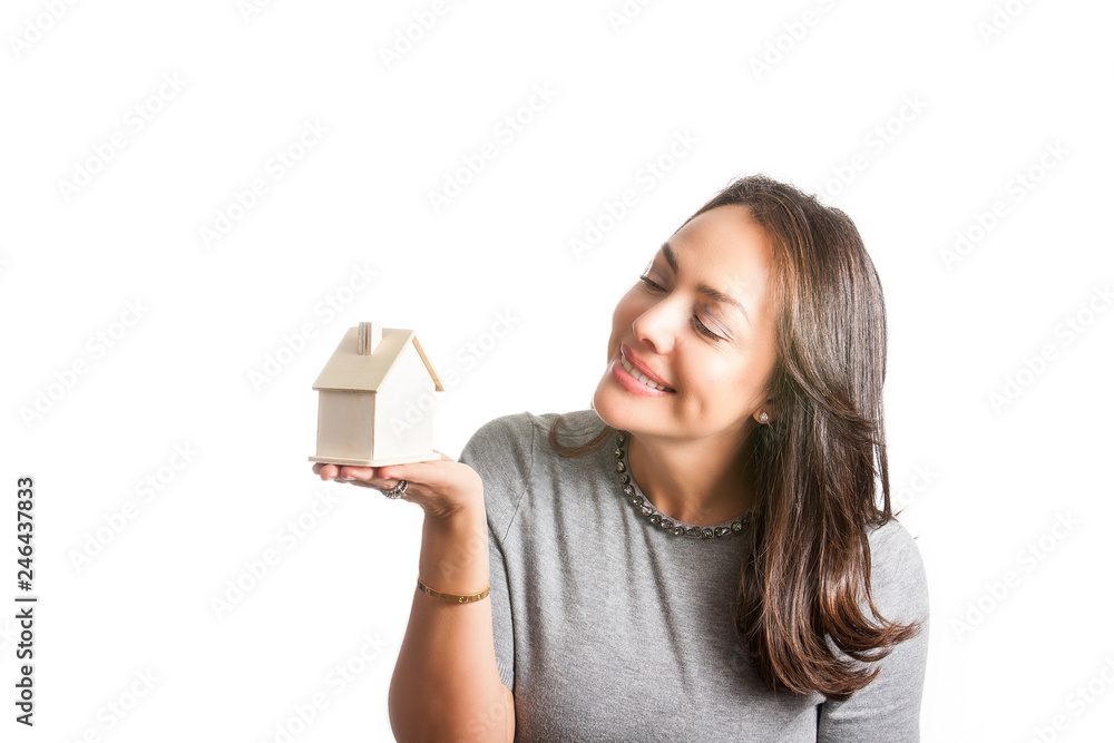 Young beautiful woman dreaming with a new house isolated on white background Young beautiful woman dreaming with a new house isolated on white background
