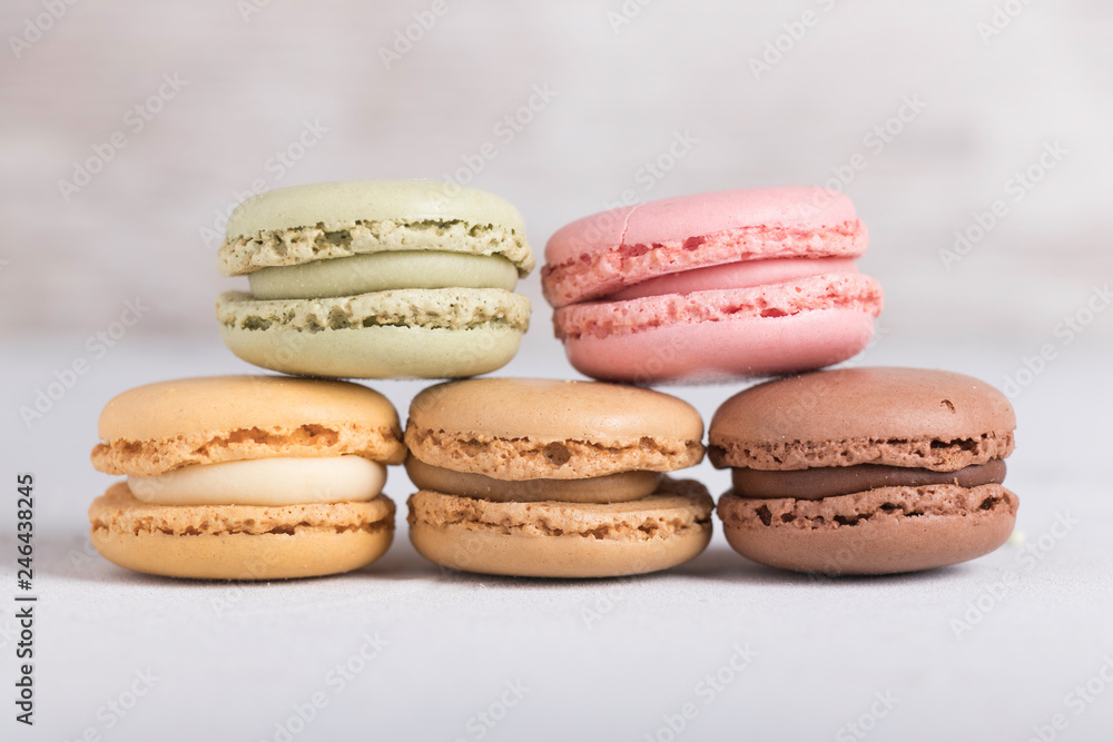 Colorful pastel macarons on gray background