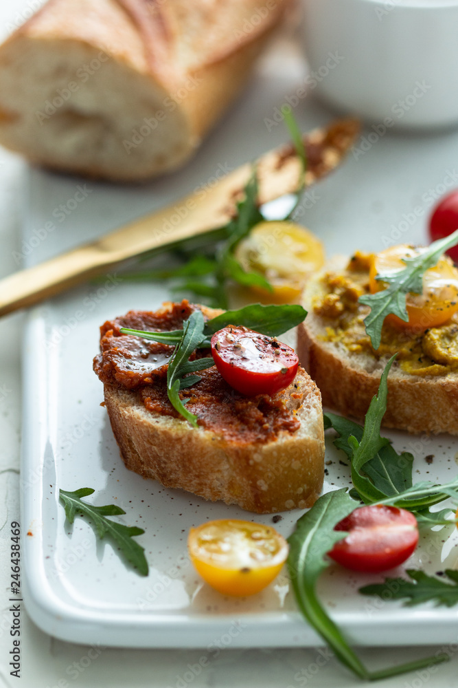 bruschettas with chopped tomato and basil on white ceramic plate. Top view. bruschettas with chopped tomato and basil on white ceramic plate. Top view.