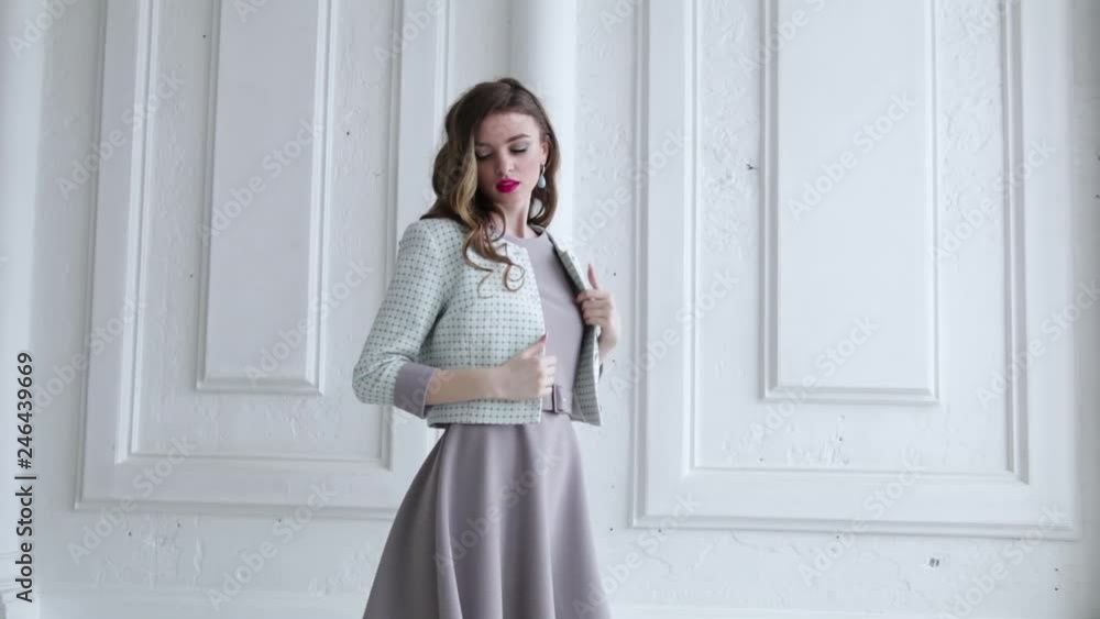 sexy girl takes off her jacket and throws it against a white wall sexy girl takes off her jacket and throws it against a white wall