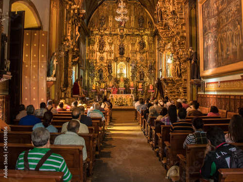 Photography interior of an old cathedral in Mexico with details, engravings and altar in gol