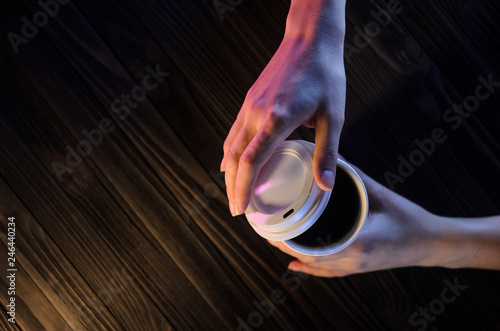 Barista serves a cup of coffee. Paper cup Plastic cap Coffee Barista Hands. Concept Coffee to go