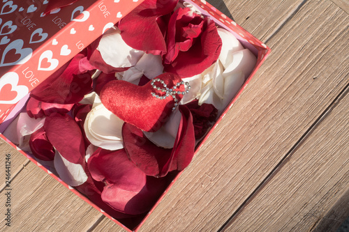 Red & White Rose petals inside the gift box, Valentine's Day greeting card, Top view on romantic composition, Romanace concepts photo