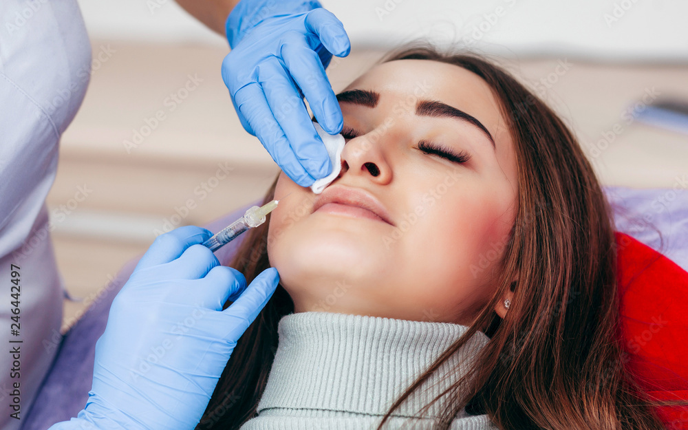 Fototapeta premium Injections of the lips. Correction form the upper lip. Injection of beauty. Spa. Facial Rejuvenation. Lip augmentation.
