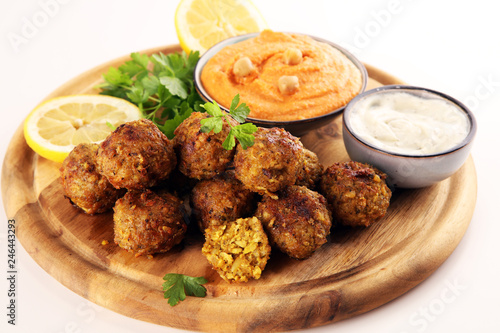 Traditional homemade hummus, falafel and chickpea served with spices on table. Jewish Cuisine.