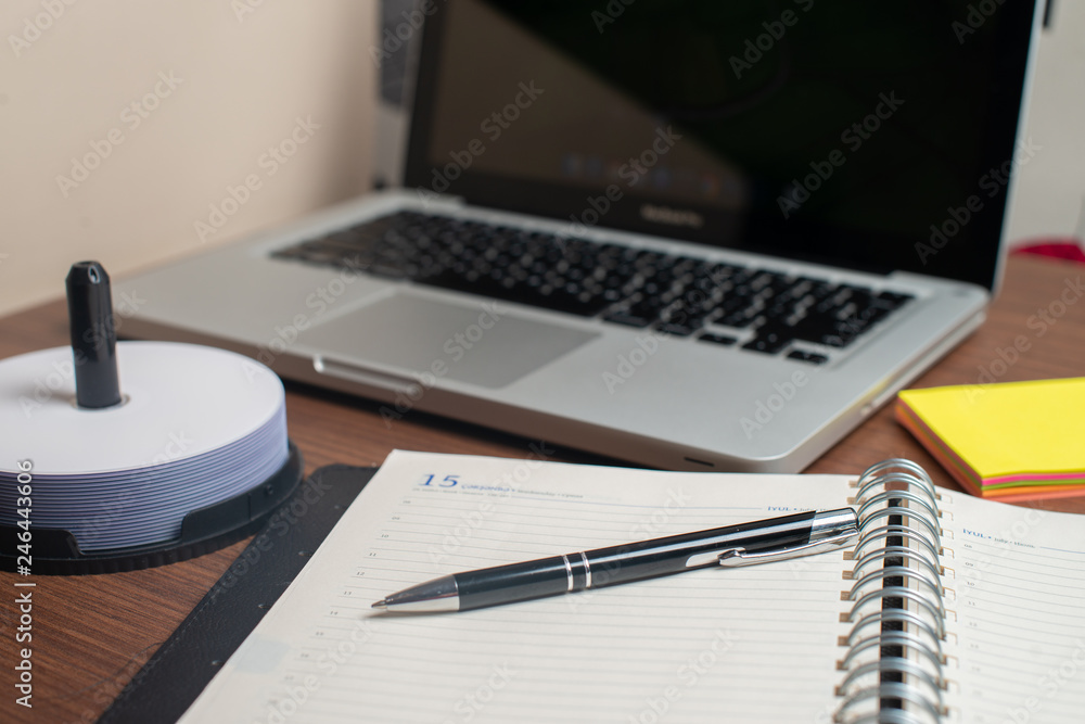 Notebook with black pen, Colorful notepads on the desk, Glasses on the desk with pen and cup of coffee, Computer keyboard with colorful note stick Notebook with black pen, Colorful notepads on the desk, Glasses on the desk with pen and cup of coffee, Computer keyboard with colorful note stick