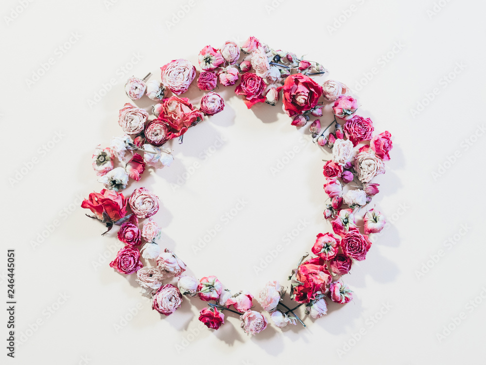Festive flower composition. Congratulation concept. Dried rose wreath on ivory background. Festive flower composition. Congratulation concept. Dried rose wreath on ivory background.