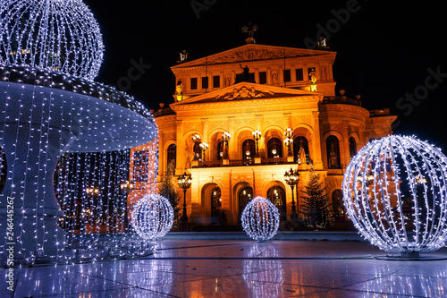 Alte Oper (Old Opera), a concert hall and former opera house in Frankfurt am Main, Germany, with Christmas decorated fountain during winter evening