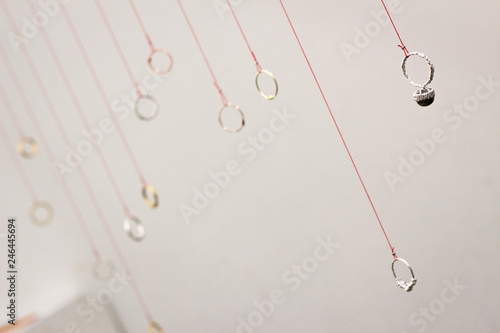 Close up of rings hanging on strings