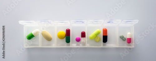 weekly pillbox with medication, conceptual image, horizontal composition photo